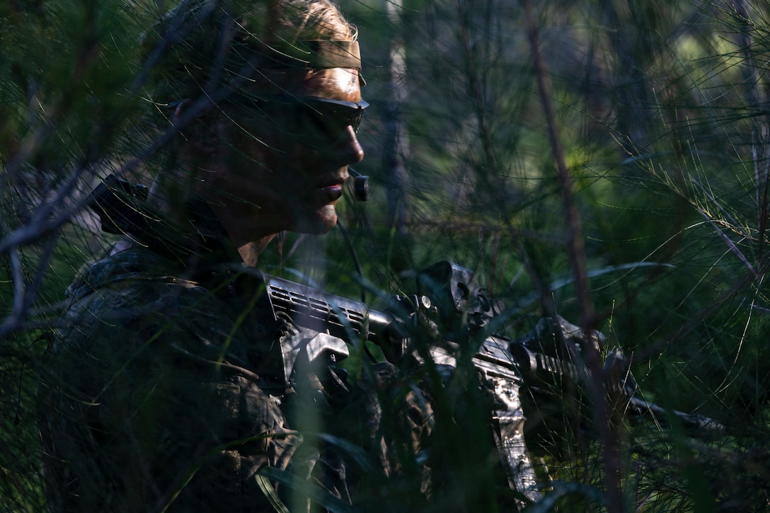 A U.S. Marine with the Maritime Raid Force, 31st Marine Expeditionary Unit, posts security during a limited scale raid on Camp Hansen, Okinawa, Japan, Nov. 21, 2022. The simulated limited scale raid was conducted to improve the Marines’ ability to plan and conduct ground movements in an austere environment. The 31st MEU, the Marine Corps' only continuously forward-deployed MEU, provides a flexible and lethal force ready to perform a wide range of military operations as the premier crisis response force in the Indo-Pacific region.