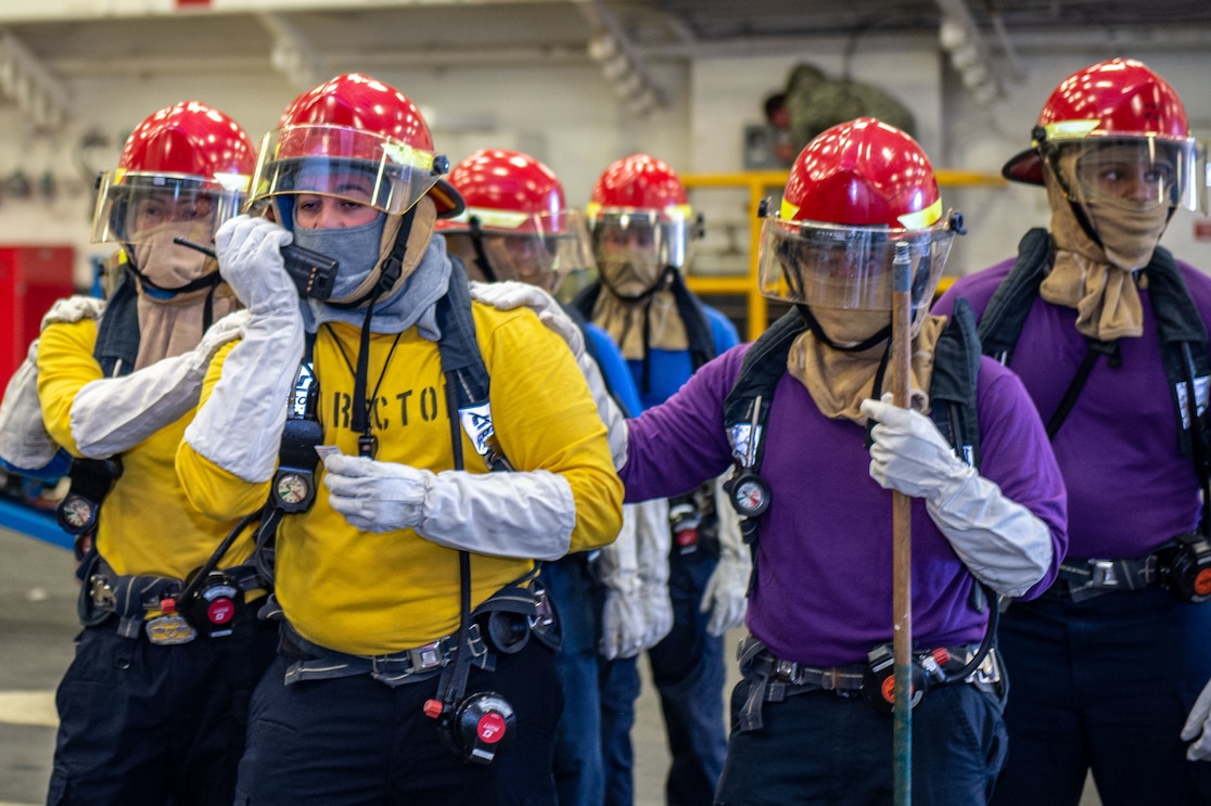 Sailors assigned to the USS Boxer’s (LHD 4) Air Department respond to a simulated fuel station fire in the hangar bay during a training exercise, Nov. 16, 2022.