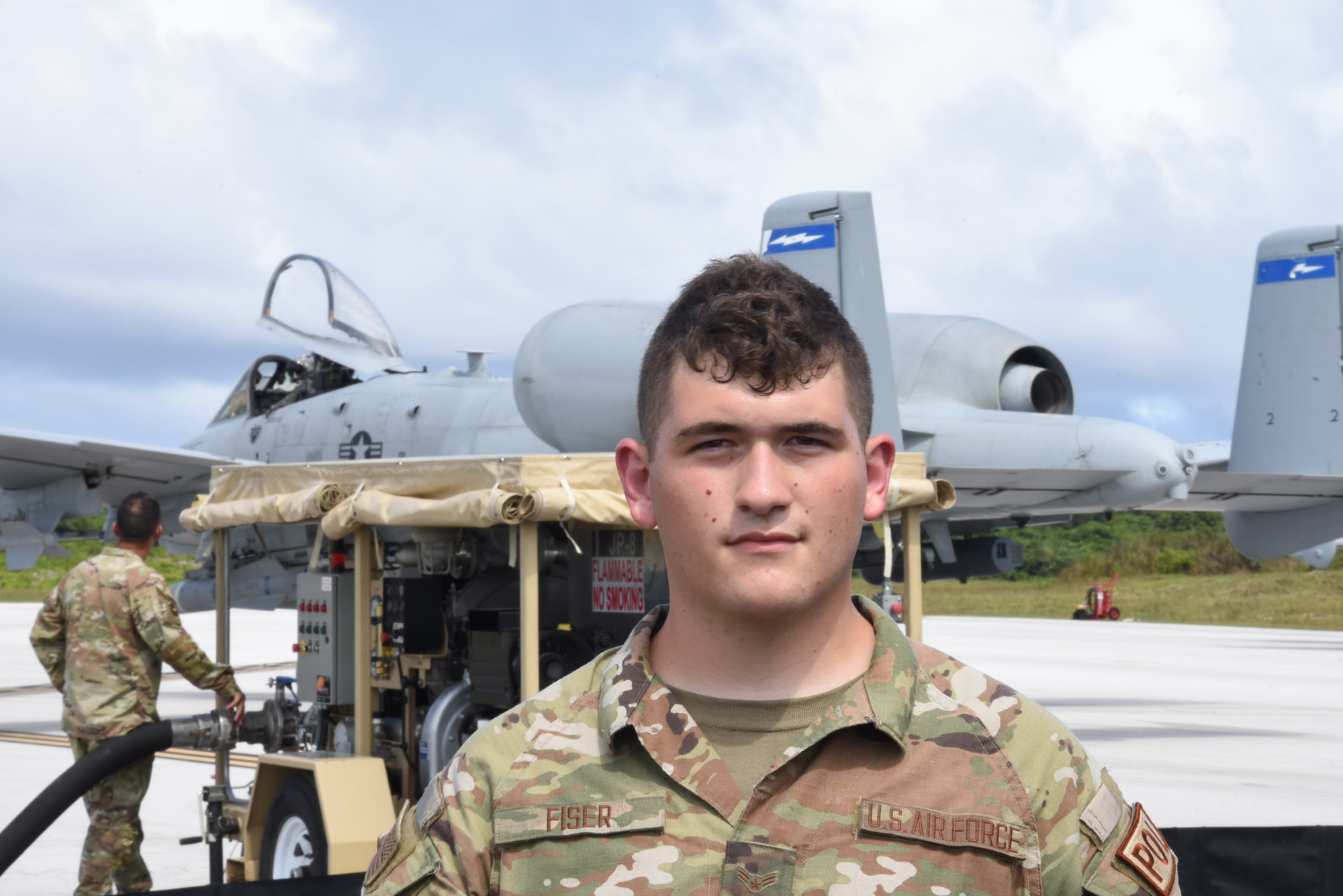 Photo of an Airman standing in front of an aircraft