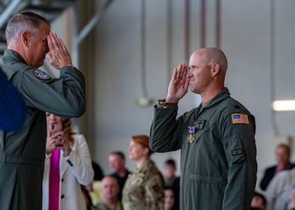 Gen. Mike Minihan returns a salute from Lt. Col. Alex Pelbath.