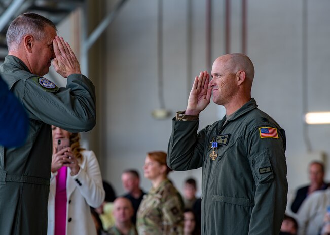 Gen. Mike Minihan returns a salute from Lt. Col. Alex Pelbath.