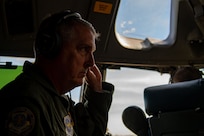 Gen. Mike Minihan listens to pilots over his aviation headset on a C-17 Globemaster III.