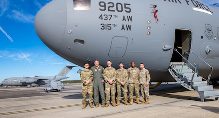 Gen. Mike Minihan takes a picture with Airmen.