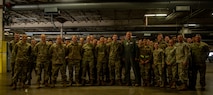 Gen. Mike Minihan takes a picture with Airmen.