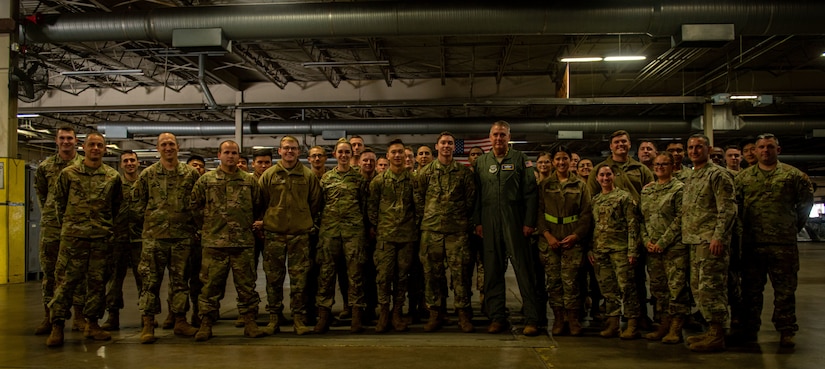 Gen. Mike Minihan takes a picture with Airmen.