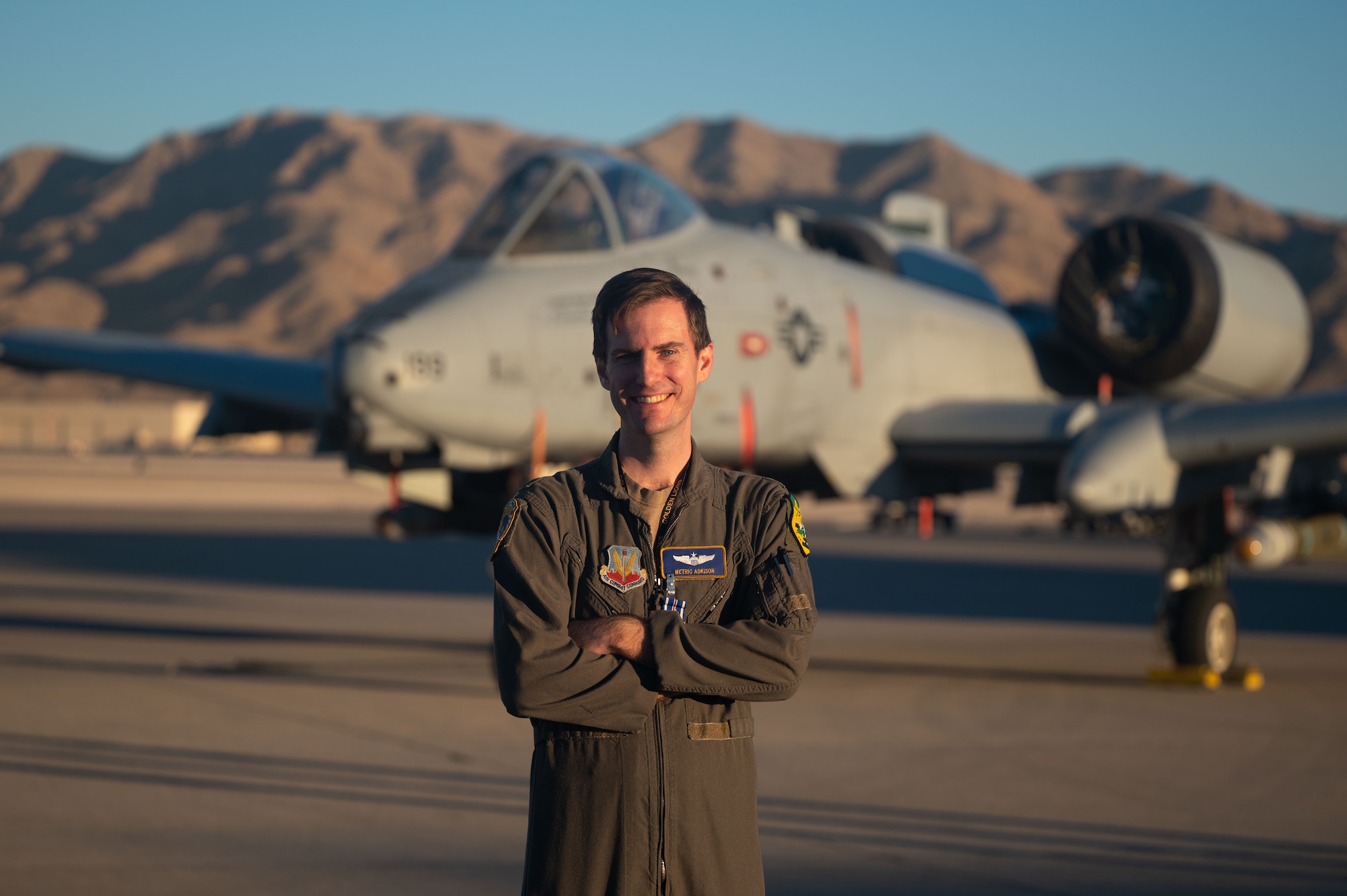 U.S. Air Force Major Kyle Adkison, A-10 Pilot assigned to the 53rd Wing is presented the Distinguished Flying Cross with Combat Device by U.S. Air Force Major General R. Scott Jobe, Director of Plans, Programs, and Requirements, Headquarters Air Combat Command, during a ceremony at Nellis Air Force Base, Nevada, Nov. 22, 2022. The "C" device was established in 2016 to distinguish an award earned for exceptionally meritorious service or achievement performed under combat conditions.