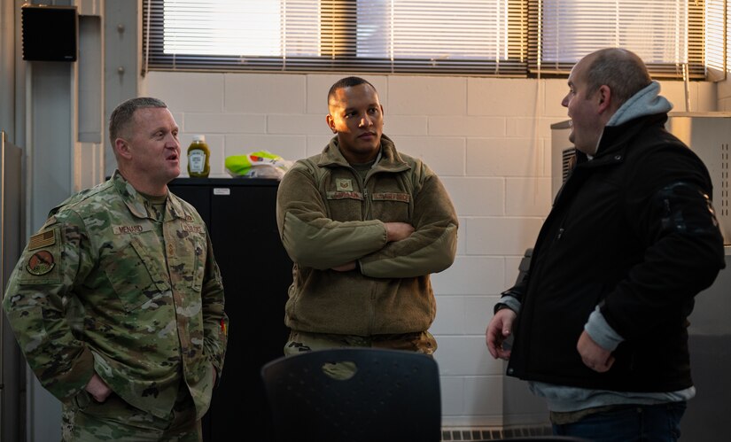 U.S. Air Force Tech. Sgt. Carlos Catalan, 305th AMW True North religious affairs superintendent, center, speaks with 305th AMW Airmen during a morale potluck at Joint Base McGuire-Dix-Lakehurst, N.J., Nov. 18, 2022.