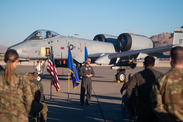 U.S. Air Force Major Kyle Adkison, A-10 Pilot assigned to the 53rd Wing is presented the Distinguished Flying Cross with Combat Service by U.S. Air Force Major General R. Scott Jobe, Director of Plans, Programs, and Requirements, Headquarters Air Combat Command, during a ceremony at Nellis Air Force Base, Nevada, Nov. 22, 2022. The distinguished flying cross is awarded for heroism or extraordinary achievement while participating in aerial flight. Both heroism and achievement must be entirely distinctive, involving operations that are not routine.
