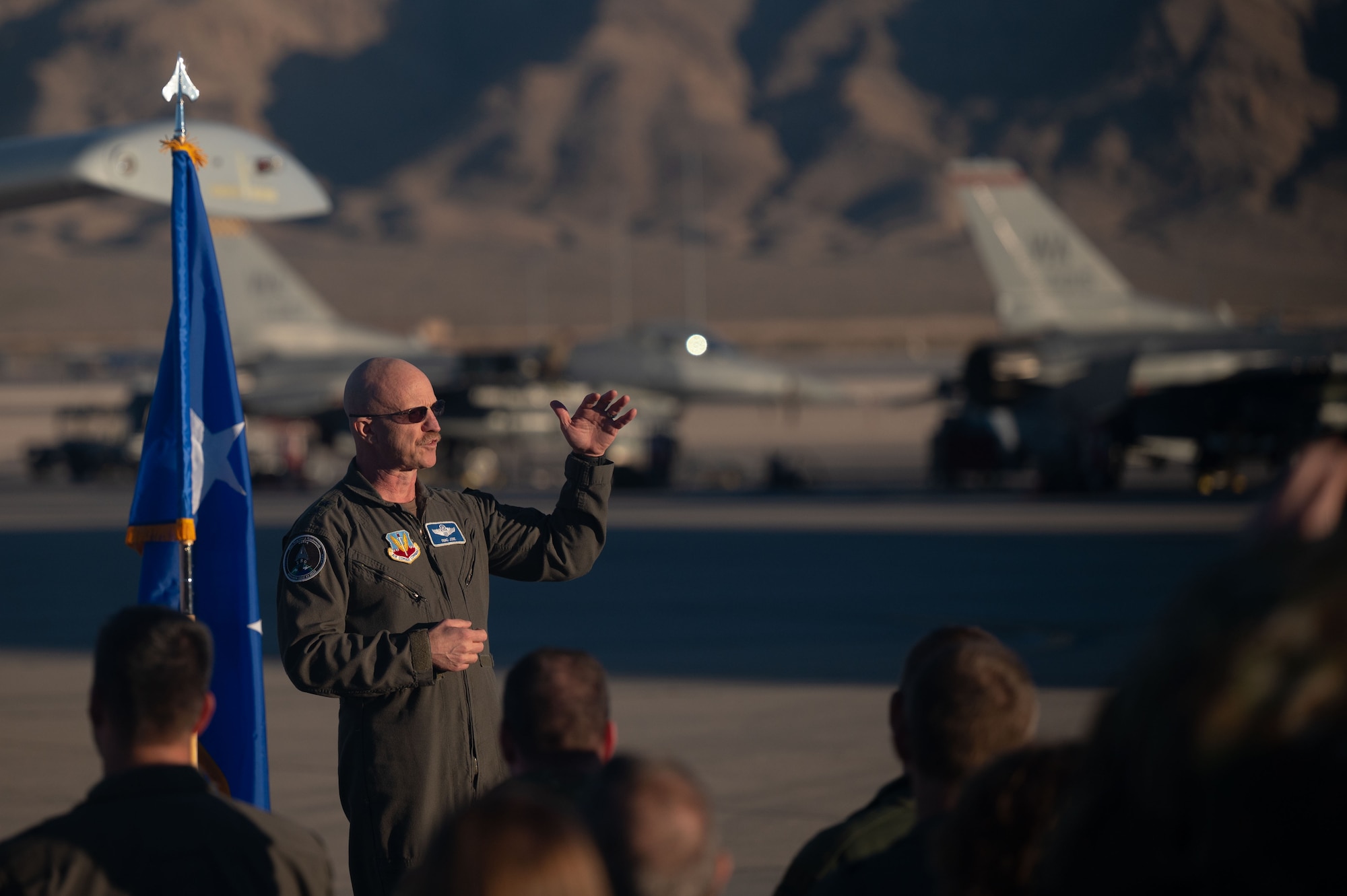 U.S. Air Force Major General R. Scott Jobe, Director of Plans, Programs, and Requirements, Headquarters Air Combat Command, speaks during a ceremony at Nellis Air Force Base, Nevada, Nov. 22, 2022. During the presentation, U.S. Air Force Major Kyle Adkison, A-10 Pilot assigned to the 53rd Wing was presented the Distinguished Flying Cross with Combat Service for extraordinary achievement while supporting Operation FREEDOM'S SENTINEL and the Resolute Support Mission in Afghanistan, August 2019.