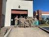 Group of people wearing a u s army uniform posing for a photo.