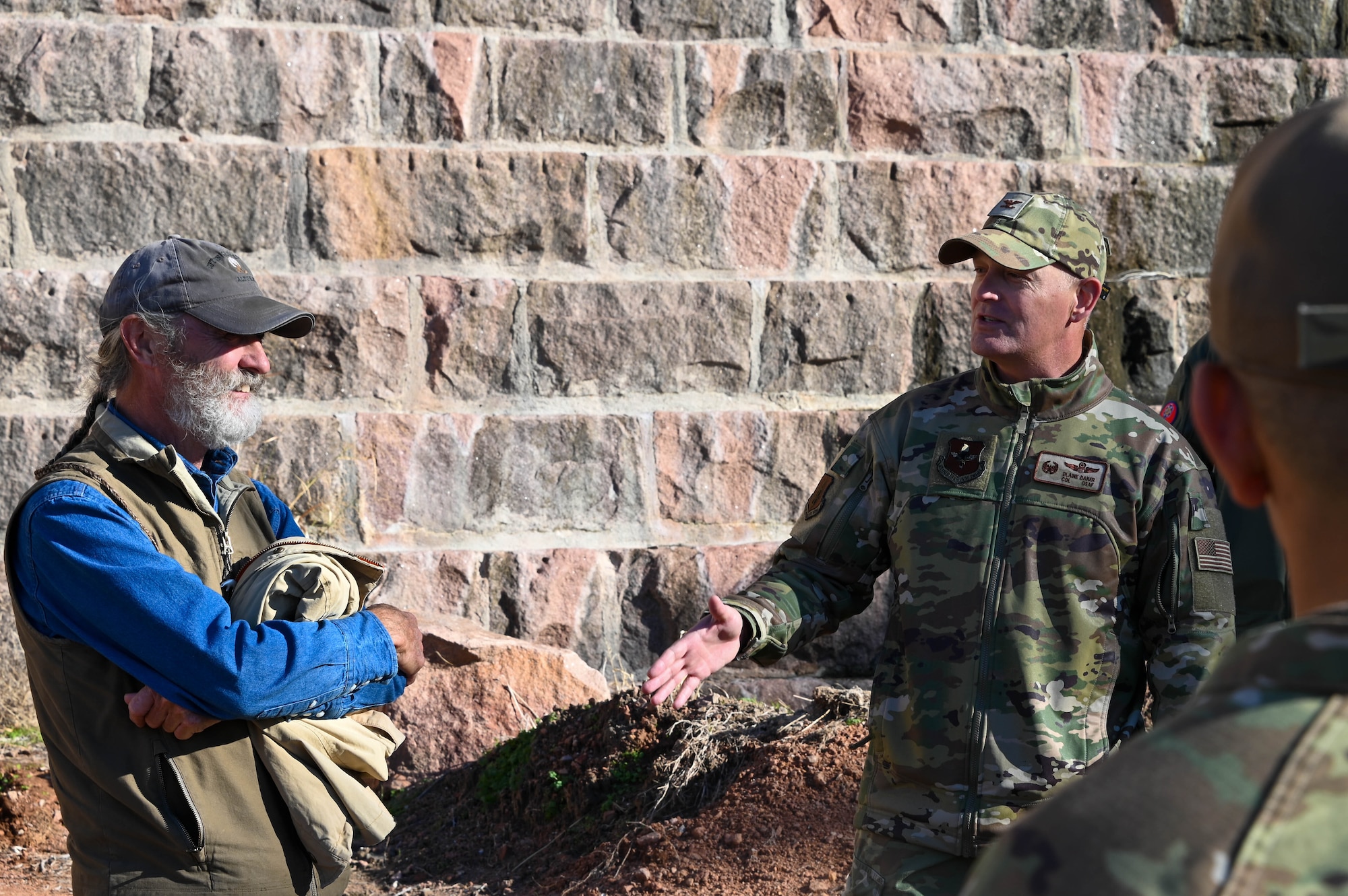 Col. Blaine Baker, 97th Air Mobility Wing commander, right, speaks to Tom Buchanan, the Altus-Lugert Irrigation District manager, about the Altus-Lugert dam at Quartz Mountain State Park, Oklahoma, Nov. 14, 2022. The dam provides water and irrigation for all the farmers in southwest Oklahoma and parts of northern Texas. (U.S. Air Force photo by Senior Airman Kayla Christenson)