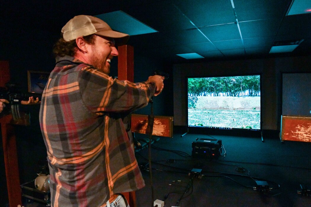 Ryan Vinyard, local farmer, shoots targets using a virtual shooting range at Altus Air Force Base, Oklahoma, Nov. 14, 2022. The firearms used are equipped with airsoft technology, providing a similar experience to firing a real handgun. (U.S. Air Force photo by Airman 1st Class Miyah Gray)
