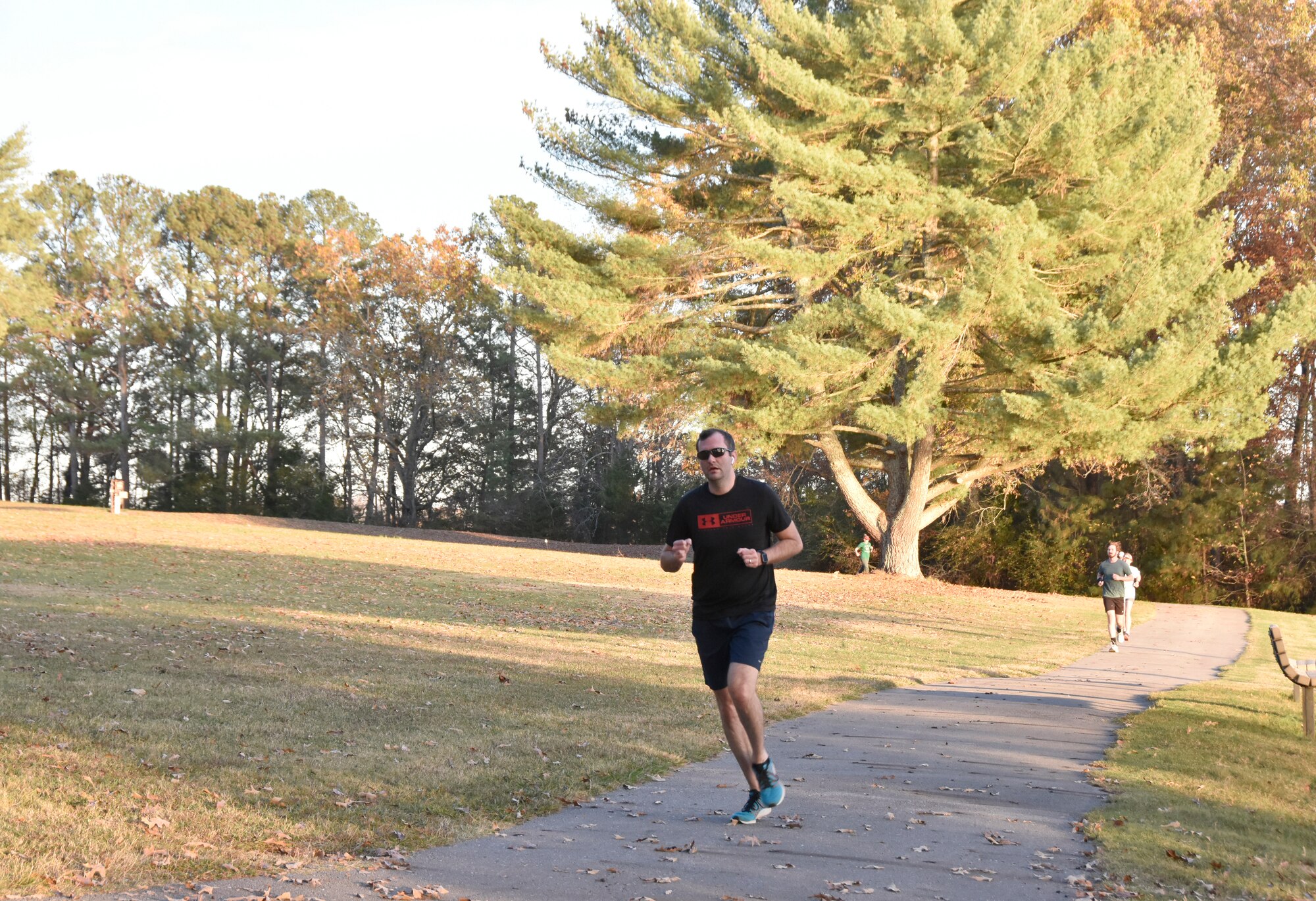 Scott Williams sprints across the trail along Woods Reservoir during the 37th annual Arnold Engineering Development Complex Turkey Trot, Nov. 9, 2022, at the Arnold Lakeside Complex on Arnold Air Force Base, Tennessee. The event drew dozens of members of the AEDC workforce and their families. (U.S. Air Force photo by Bradley Hicks)