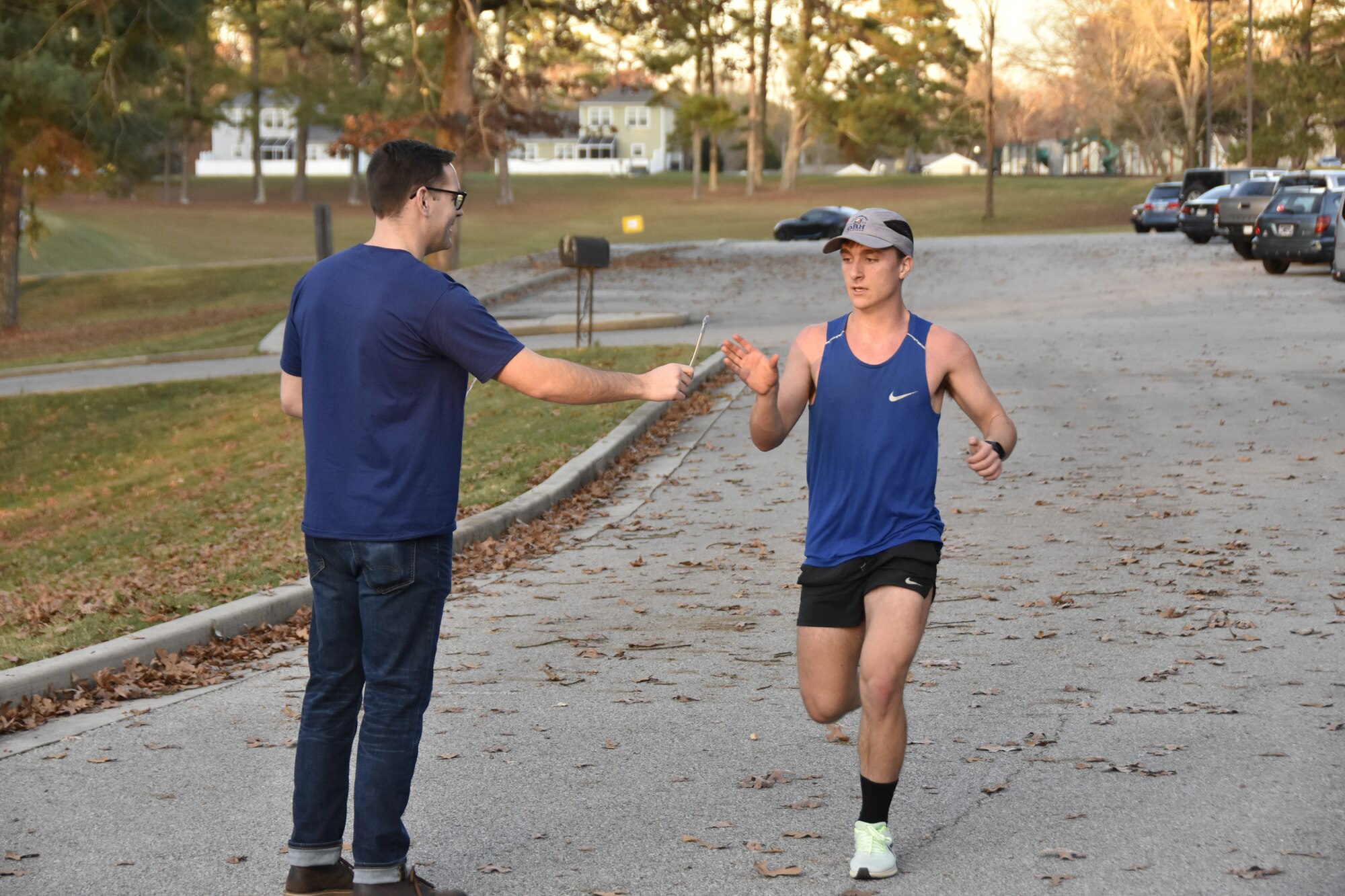 William Slabaugh, right, receives a popsicle stick from 1st Lt. Adam Doyle after crossing the finish line of the 37th annual Arnold Engineering Development Complex Turkey Trot, Nov. 9, 2022, at Arnold Air Force Base, Tennessee. Numbered sticks were given to each runner as they completed the race to indicate his or her finishing place. The event drew dozens of members of the AEDC workforce and their families. (U.S. Air Force photo by Bradley Hicks)