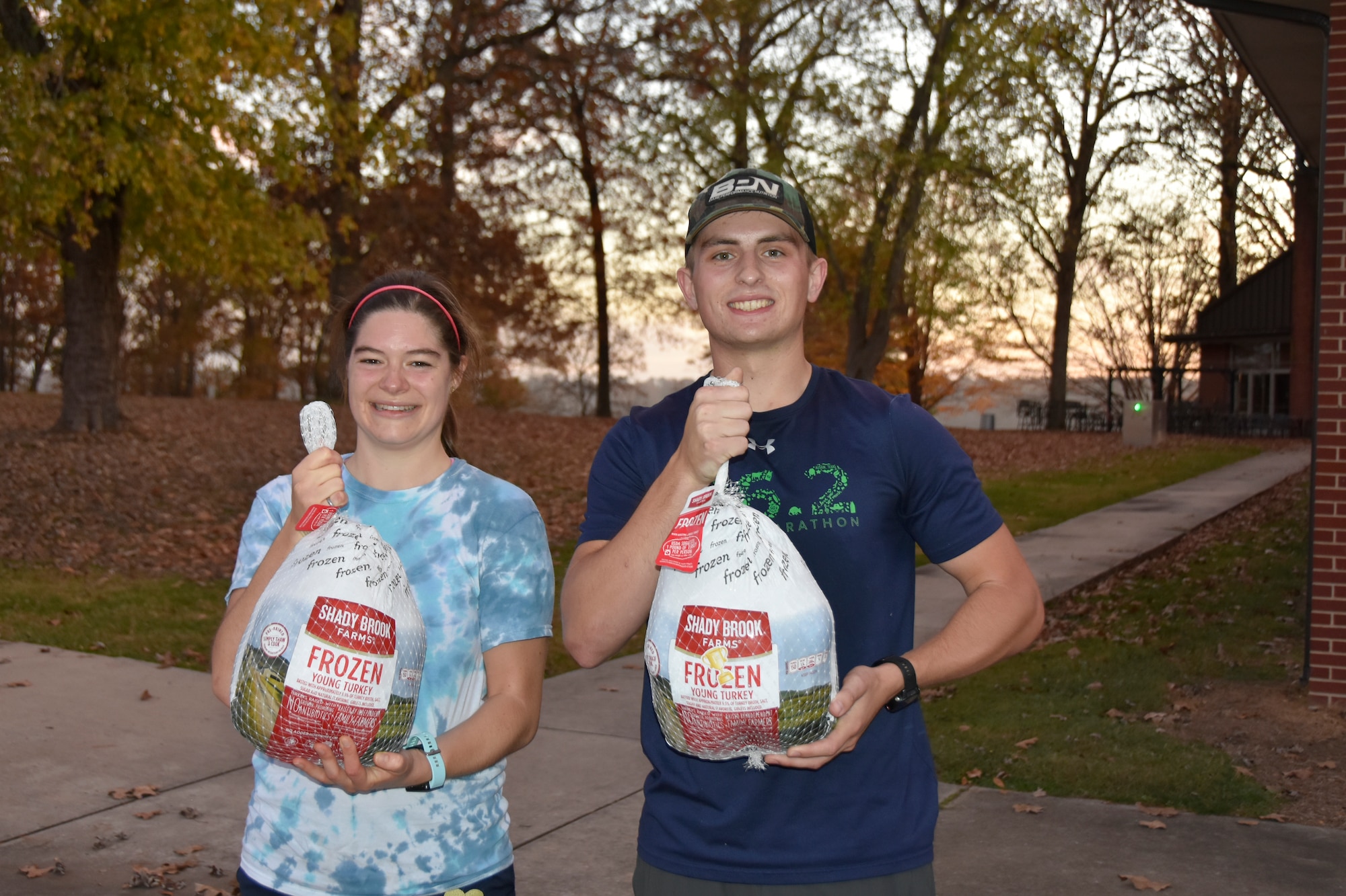 Anna Burger and 2nd Lt. Patrick Robbins display the frozen turkeys they won for being the first female and male runners to cross the finish line during the 37th annual Arnold Engineering Development Complex Turkey Trot, Nov. 9, 2022, at the Arnold Lakeside Complex on Arnold Air Force Base, Tennessee. The Turkey Trot drew dozens of members of the AEDC workforce and their families. (U.S. Air Force photo by Bradley Hicks)