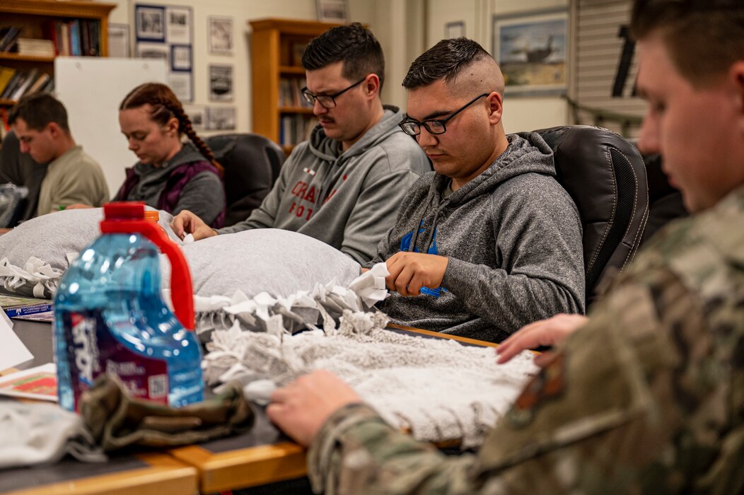 A group of people make pillows.