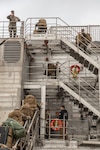 U.S. Marines assigned to II Marine Expeditionary Force (MEF) wave to onlookers ashore from aboard the Spearhead-class expeditionary fast transport USNS Trenton (T-EPF 5) in Koper, Slovenia, Nov. 16, 2022. Marines assigned to II MEF, based out of Camp Lejeune, North Carolina, embarked aboard USNS Trenton (T-EPF 5) to improve interoperability while refining the U.S. capability to rapidly deploy forces aboard U.S. Navy expeditionary fast transport vessels. (U.S. Marine Corps photo by Sgt. Scott Jenkins)