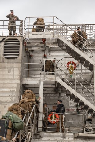 U.S. Marines assigned to II Marine Expeditionary Force (MEF) wave to onlookers ashore from aboard the Spearhead-class expeditionary fast transport USNS Trenton (T-EPF 5) in Koper, Slovenia, Nov. 16, 2022. Marines assigned to II MEF, based out of Camp Lejeune, North Carolina, embarked aboard USNS Trenton (T-EPF 5) to improve interoperability while refining the U.S. capability to rapidly deploy forces aboard U.S. Navy expeditionary fast transport vessels. (U.S. Marine Corps photo by Sgt. Scott Jenkins)