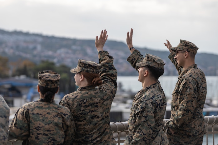 U.S. Marines assigned to II Marine Expeditionary Force (MEF) wave to onlookers ashore from aboard the Spearhead-class expeditionary fast transport USNS Trenton (T-EPF 5) in Koper, Slovenia, Nov. 16, 2022. Marines assigned to II MEF, based out of Camp Lejeune, North Carolina, embarked aboard USNS Trenton (T-EPF 5) to improve interoperability while refining the U.S. capability to rapidly deploy forces aboard U.S. Navy expeditionary fast transport vessels. (U.S. Marine Corps photo by Sgt. Scott Jenkins)
