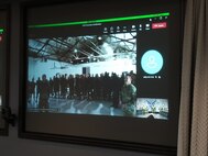 Members at Hill AFB watch as Air Force Sustainment Center Commander, Lt. Gen. Stacey T. Hawkins promoted a 649th Munitions Squadron member via video teleconference from Tinker AFB, Oklahoma.