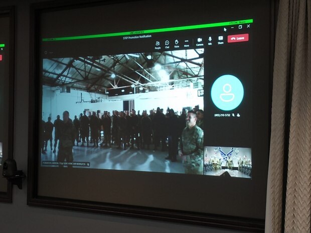 Members at Hill AFB watch as Air Force Sustainment Center Commander, Lt. Gen. Stacey T. Hawkins promoted a 649th Munitions Squadron member via video teleconference from Tinker AFB, Oklahoma.