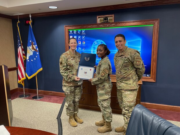 SSgt Sydney Robinson stands with 78th Air Base Wing Commander Col. Lindsay Droz and 78th ABW Command Chief Master Sgt. Luis Magana.