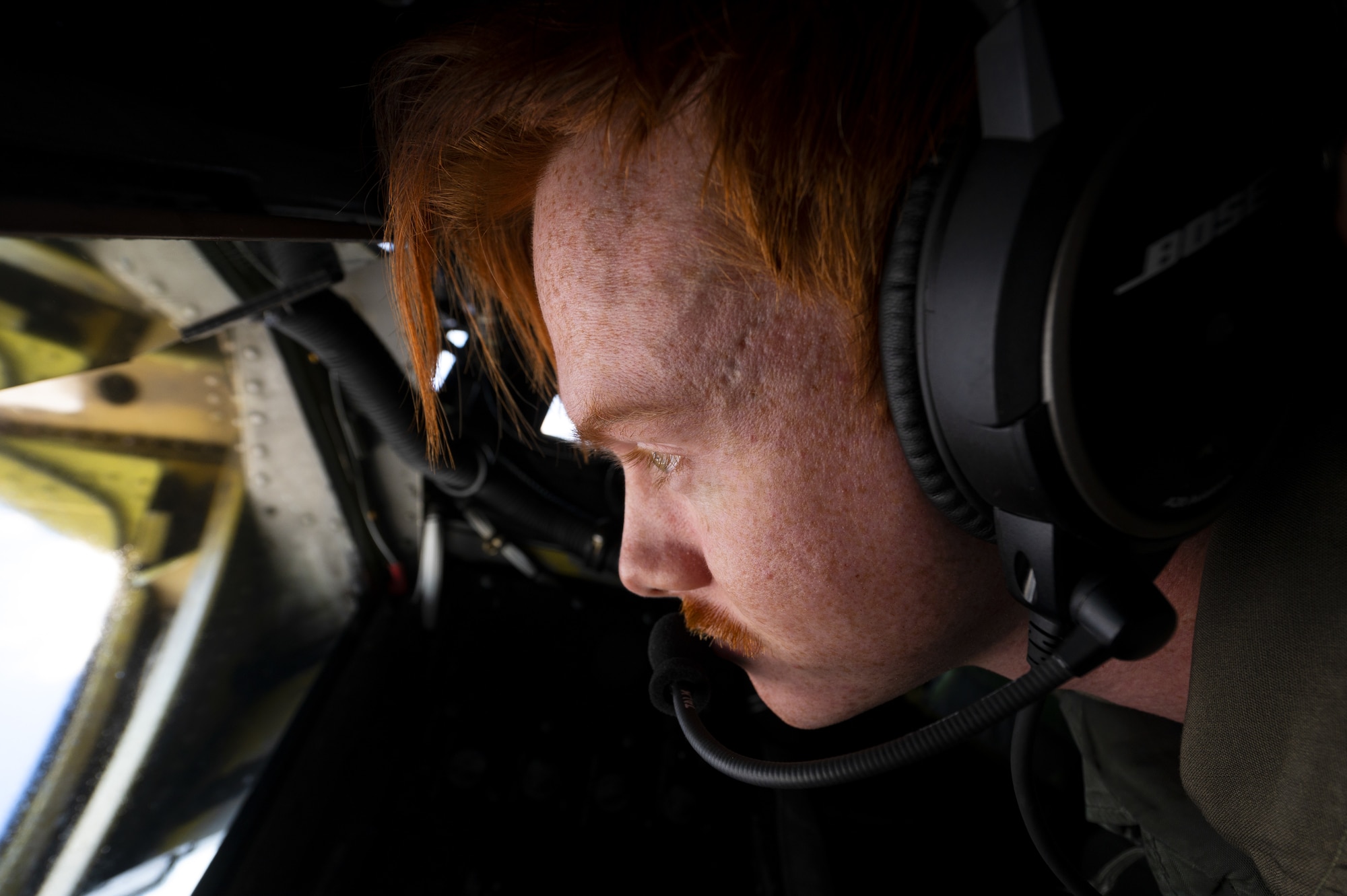 U.S. Air Force Senior Airman Dakota Griffis, 384th Air Refueling Squadron in-flight refueling specialist, prepares to refuel a C-17 Globemaster III aircraft over the Pacific Ocean, Nov. 21, 2022. The mission required the crew to fly to Travis AFB, California, where they loaded 8,000 pounds of cargo and supplies, followed by providing air refueling training for a C-17 from JBPHH. (U.S. Air Force photo by Staff Sgt. Lawrence Sena)