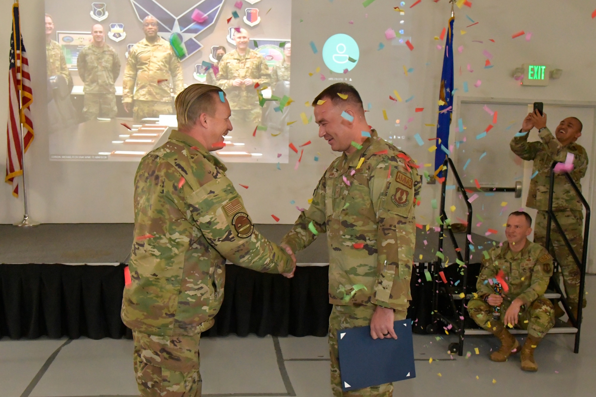 Technical Sgt. Daniel Maloney, 649th Munitions Squadron, shakes hands with Tech. Sgt. Alexander Merrill, 649th MUNS,