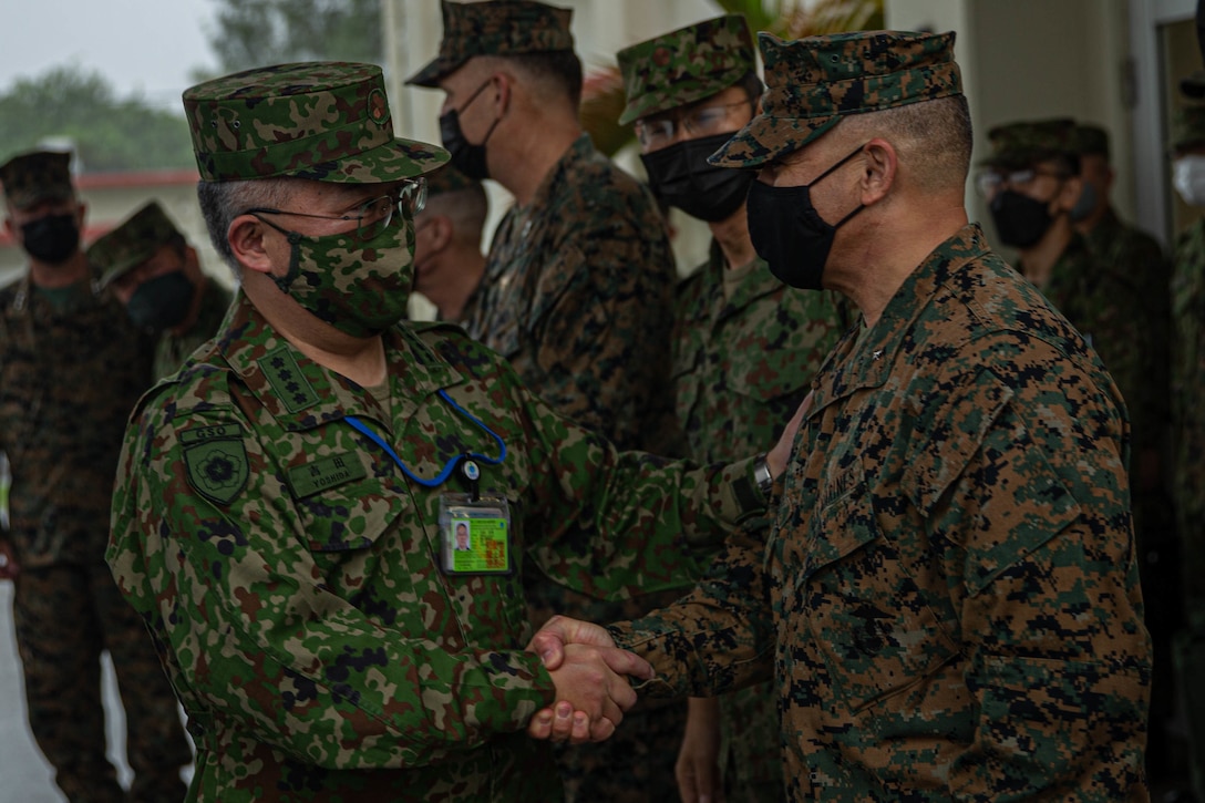 U.S. Marine Corps Brig. Gen. Adam L. Chalkley, commanding general of 3rd Marine Logistics Group, welcomes Gen. Yoshihide Yoshida, the chief of staff of the Japan Ground Self-Defense Force, to 3rd MLG Headquarters, during a bilateral key leader engagement for exercise Keen Sword 23 on Camp Kinser, Okinawa, Japan Nov. 10, 2022. Keen Sword is a biennial training event that exercises the combined capabilities and lethality developed between 3rd MLG, III Marine Expeditionary Force, and the Japan Self-Defense Force. This bilateral field-training exercise between the U.S. military and JSDF strengthens interoperability and combat readiness of the U.S.-Japan Alliance. (U.S. Marine Corps photo by Lance Cpl. Weston Brown)