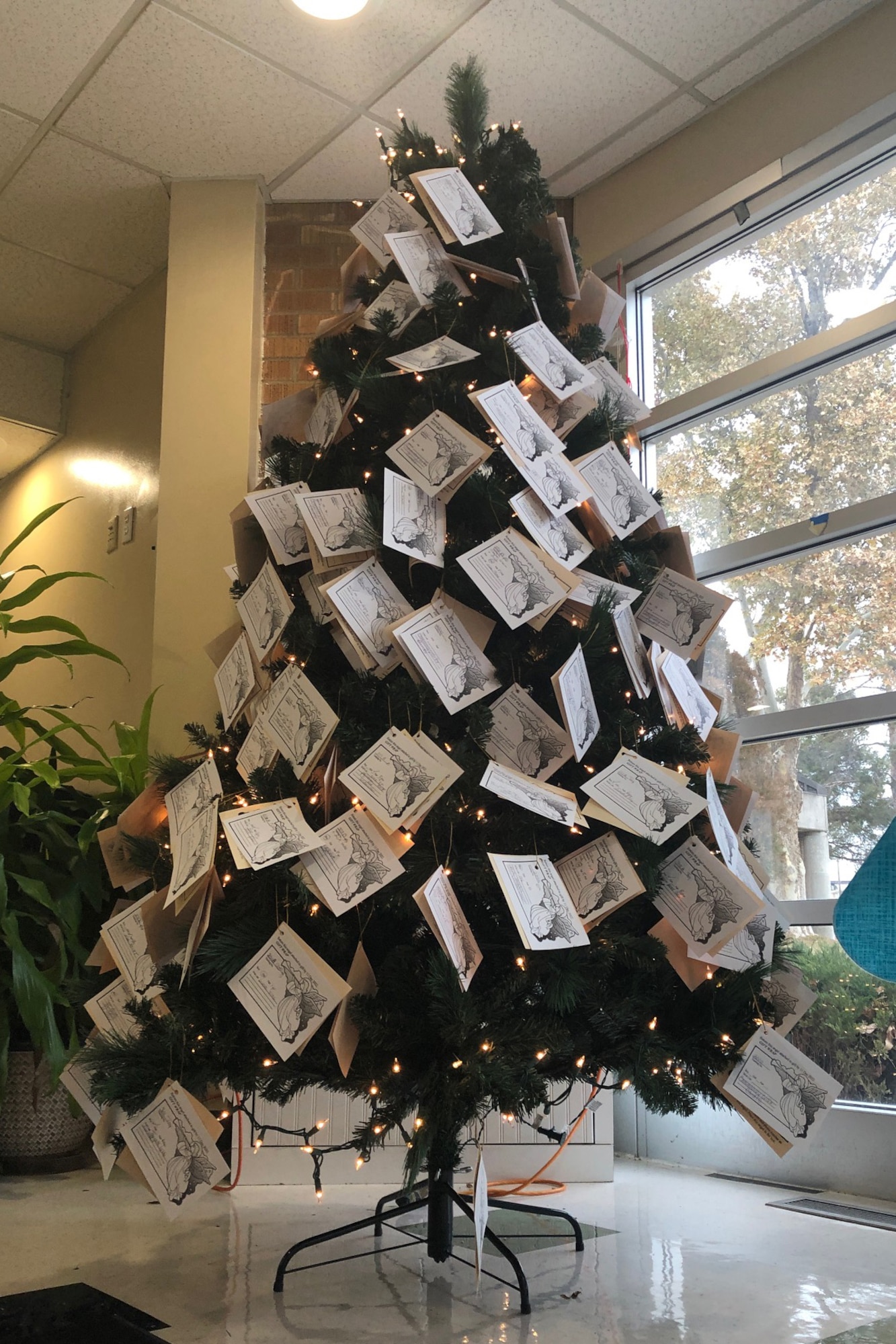 A Christmas tree with angel-shaped papers