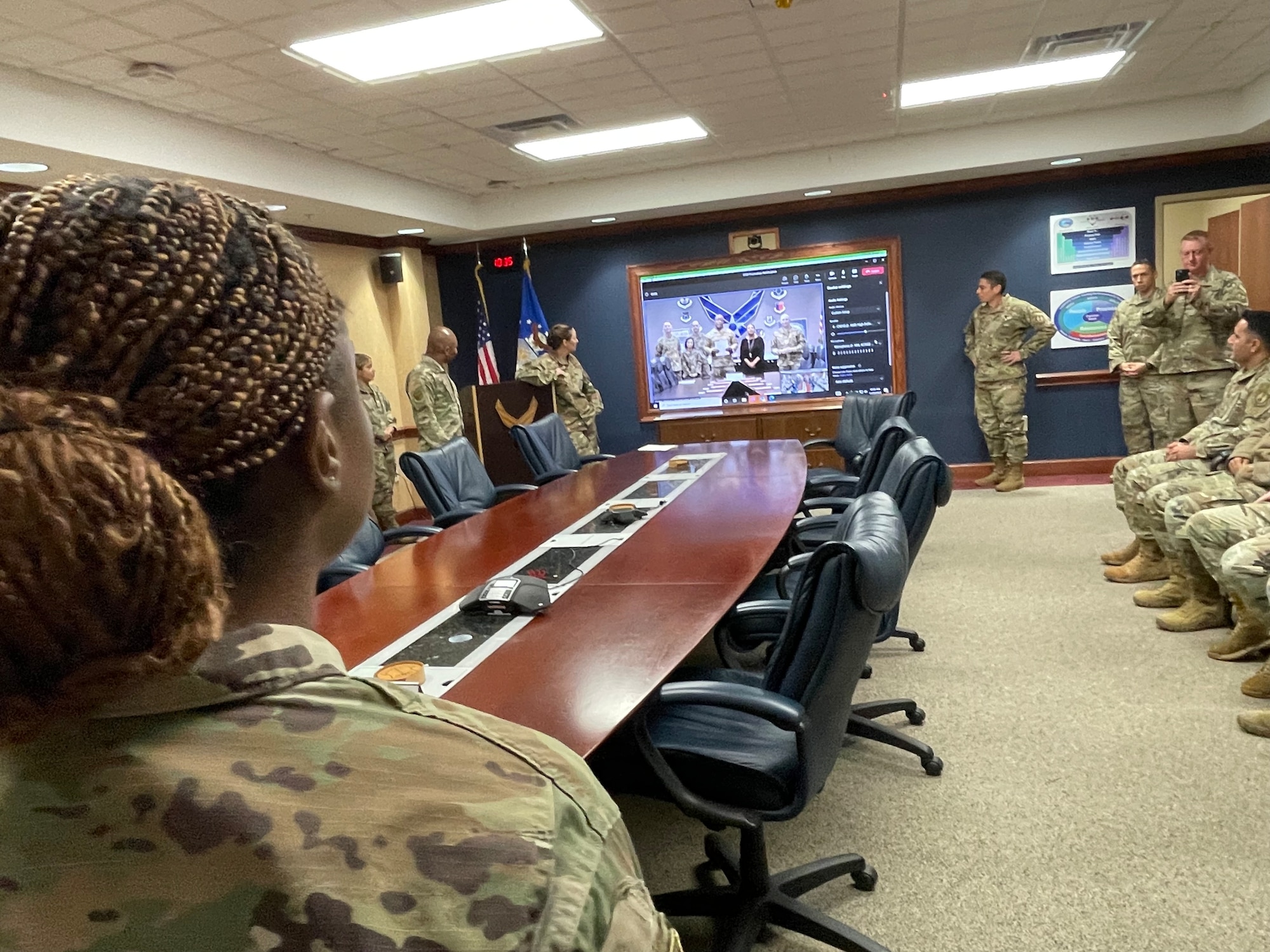 Team Robins watches as Air Force Sustainment Center Commander, Lt. Gen. Stacey T. Hawkins promoted two 78th Logistics Readiness Squadron members member via video teleconference from Tinker AFB, Oklahoma. (U.S. Air Force Photo by Kent Cummins)