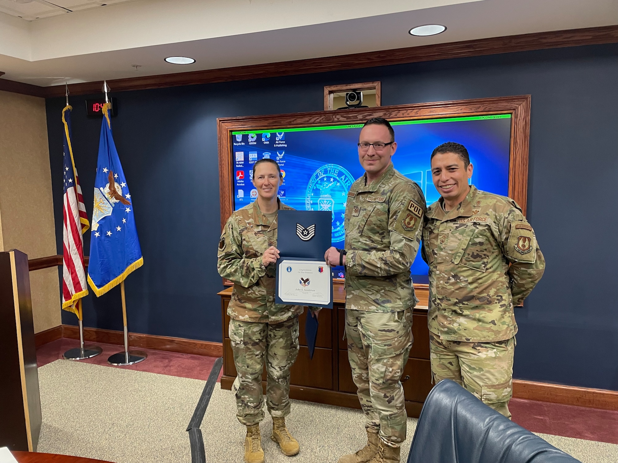 TSgt. John Sanderson stand with 78th Air Base Wing Commander Col. Lindsay Droz and 78th ABW Command Chief Master Sgt. Luis Magana.