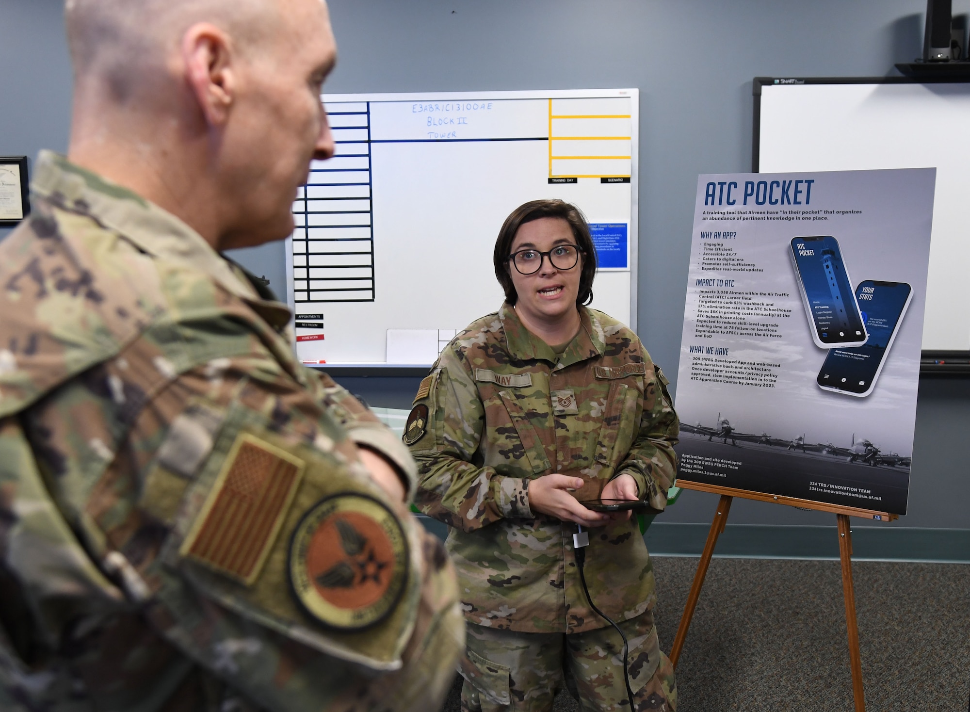 U.S. Air Force Tech. Sgt. Courtney Way, 334th Training Squadron instructor, provides an overview of the air traffic control pocket app capabilities to Gen. David Allvin, Vice Chief of Staff of the Air Force, inside Cody Hall at Keesler Air Force Base, Mississippi, Nov. 18, 2022.
