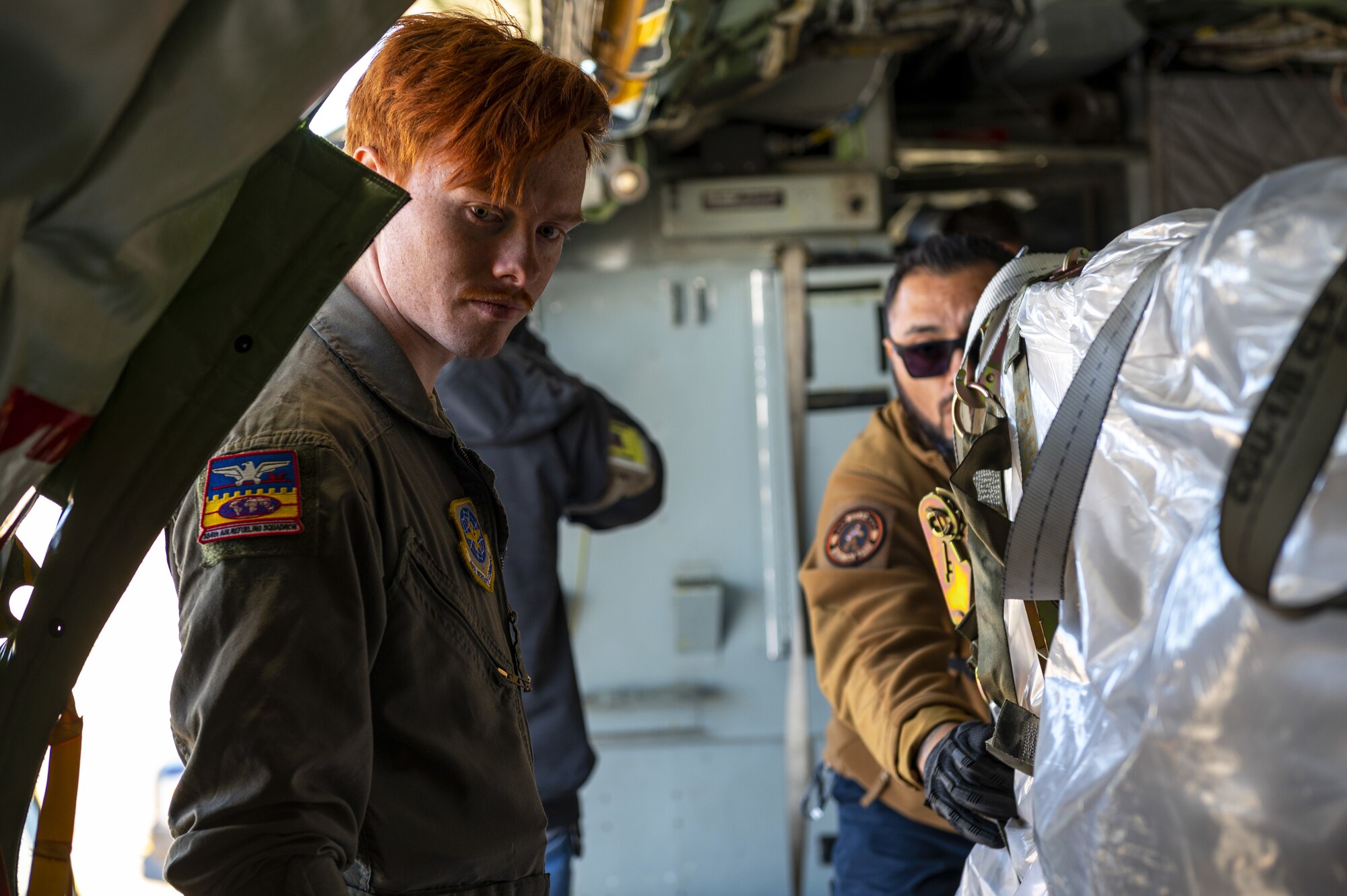 U.S. Air Force Senior Airman Dakota Griffis, 384th Air Refueling Squadron in-flight refueling specialist, inspects cargo during loading at Travis Air Force Base, California, Nov. 19, 2022. Despite the primary mission of the KC-135 Stratotanker aircraft being air refueling, the 92nd Air Refueling Wing employs its Stratotankers to support multiple mission sets such as aeromedical evacuation, cargo, and command and control. (U.S. Air Force photo by Staff Sgt. Lawrence Sena)