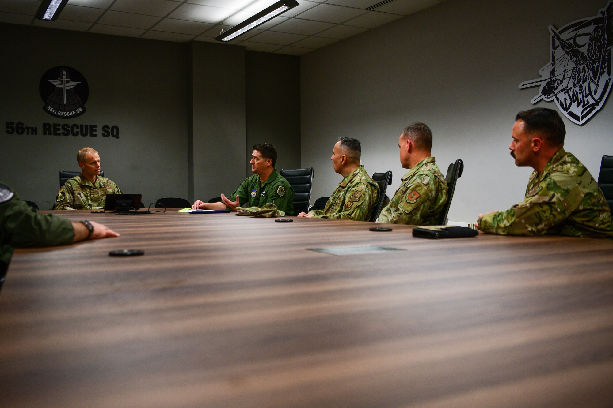 U.S. Air Force Lt. Col. Adam Hawkins, 56th Rescue Squadron commander, briefs U.S. Air Force Maj. Gen. Derek France, Third Air Force commander, on the 56th RQS mission and capabilities at Aviano Air Base, Italy, Nov. 21, 2022. The 56th RQS provides a rapidly-deployable, worldwide combat rescue and reaction force response utilizing HH-60G Pave Hawk helicopters. (U.S. Air Force photo by Senior Airman Brooke Moeder)