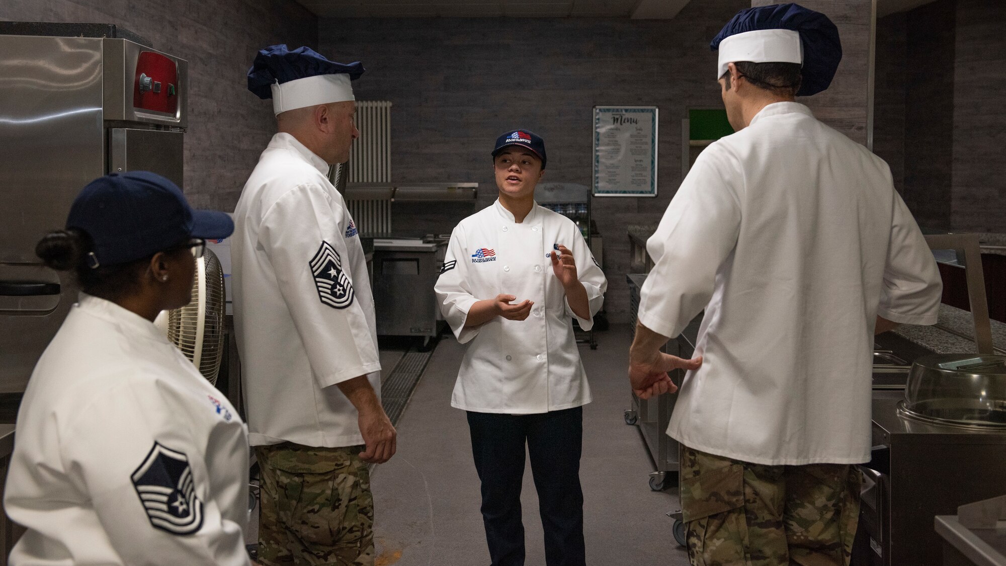 woman briefs two members of wing leadership