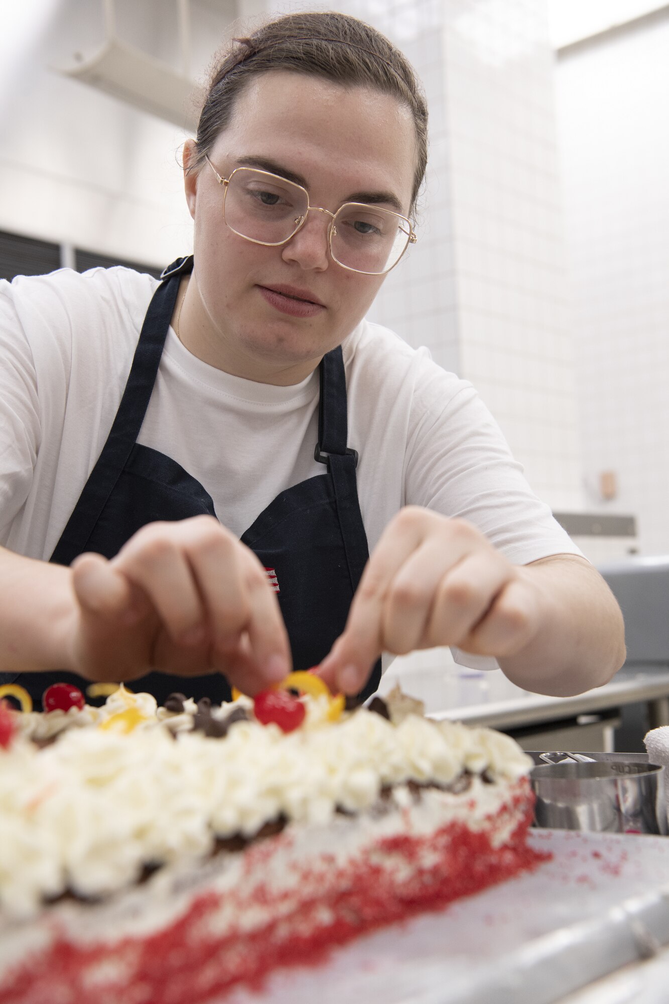 Staff Sgt. Kylee Masters Thomas, 374th Force Support Squadron food service shift leader, decorates a cake in preparation to serve Thanksgiving meals at the Samurai Café Dining Facility at Yokota Air Base, Japan, Nov. 24, 2022. U.S. Ambassador to Japan Rahm Emanuel, U.S. Air Force Lt. Gen. Ricky Rupp, Commander of U.S. Forces Japan and Fifth Air Force, and 374th Airlift Wing leadership, took time to serve and celebrate Thanksgiving Day alongside service members and families assigned to Yokota. (U.S. Air Force photo by Tech. Sgt. Christopher Hubenthal)