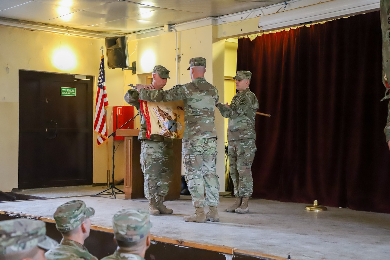 Sgt. 1st Class Samuel Ryder and Lt. Col. Nathan Wall, command team for the 746th Combat Sustainment Support Battalion, case the unit colors during a transfer of authority ceremony with 68th Division Sustainment Support Battalion at Forward Operating Site Powidz, Poland, Nov. 22, 2022. The casing of the colors is an Army tradition symbolizing proper relief of the outgoing unit.