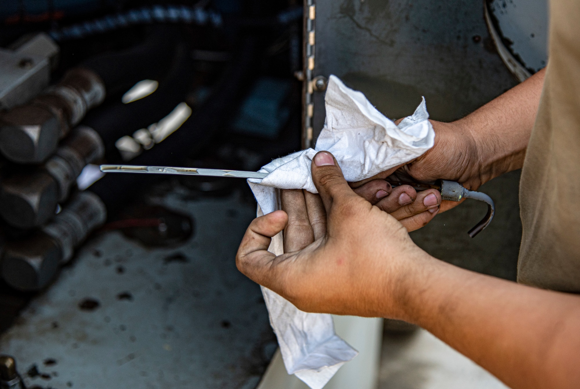 Senior Airman Jacob Karn, an Aerospace Ground Equipment Mechanic with the 332d Expeditionary Maintenance Squadron, checks the oil on a hydraulic mule at an undisclosed location, Southwest Asia, Nov. 14, 2022. This hydraulic mule is used to test moving parts of an F-15E Fighting Falcon, such as wing flaps and landing gear. (U.S. Air Force photo by: Tech. Sgt. Jim Bentley)