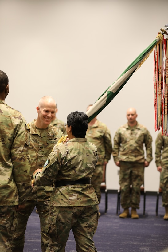 Col. James Slaughter, outgoing commander for 2nd Psychological Operations Group, passes the colors to Brig. Gen. Andrée Carter, deputy commanding general of the U.S. Army Civil Affairs and Psychological Operations Command (Airborne) who presided over the ceremony that took place at the Pro Football Hall of Fame, Canton, Ohio, on November 5, 2022. (US Army Photo Sgt. 1st Class Kevin Rayan)