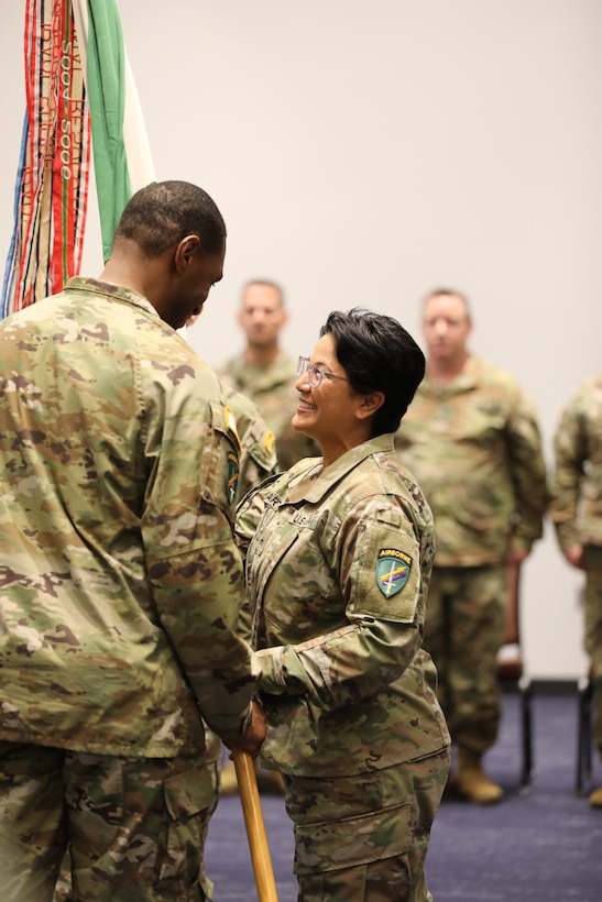 Brig. Gen. Andree Carter, deputy commanding general of the U.S. Army Civil Affairs and Psychological Operations Command (Airborne), passes the colors to Col. Lawrence Williams, incoming commander for 2nd Psychological Operations Group, during the change of command ceremony that was held November 5, 2022, at the Pro Football Hall of Fame Center in Canton, Ohio. (US Army Photo Sgt. 1st Class Kevin Rayan)