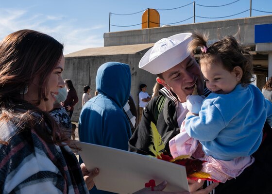 A Sailor reunites with his family following the return of the first-in-class aircraft carrier USS Gerald R. Ford (CVN 78) to Naval Station Norfolk, Nov. 26.