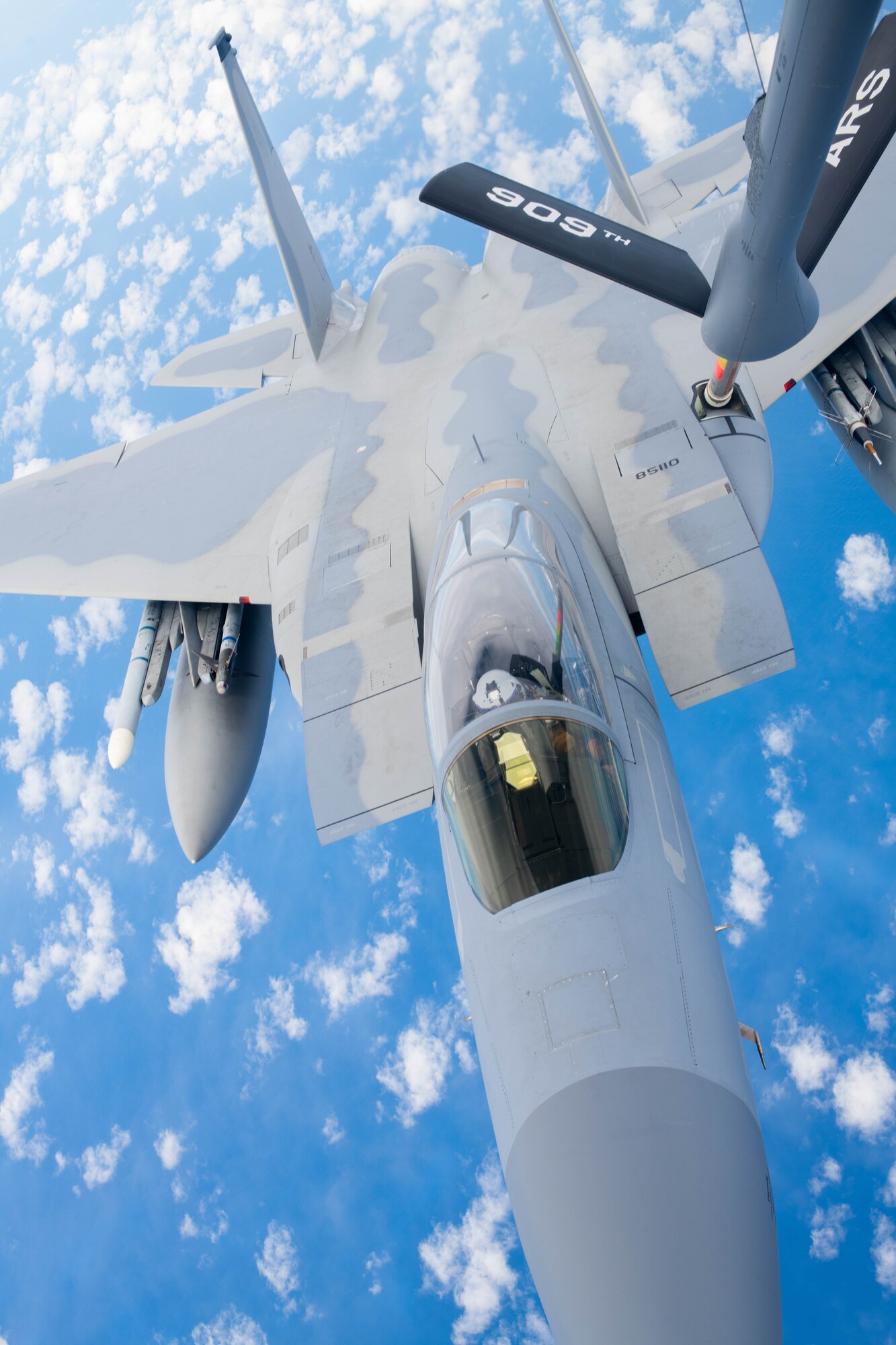 A jet receives aerial refueling.