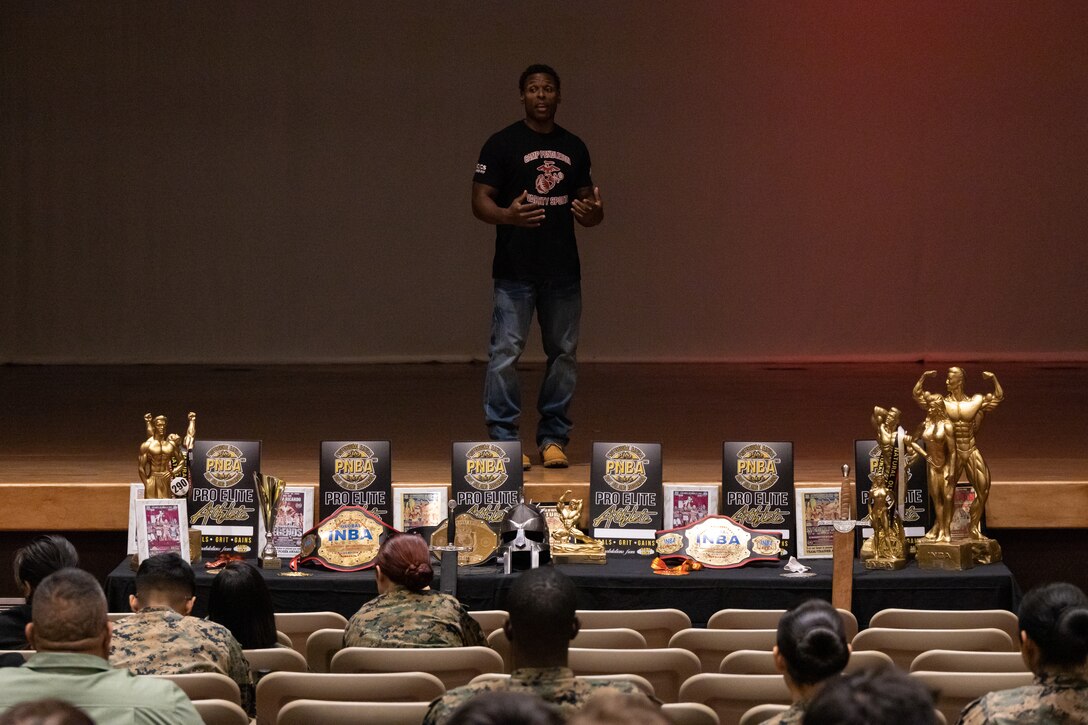 U.S. Marine Corps Master Sgt. Ausar, the staff non-commissioned officer in charge of Regional Disbursing Office-West, Combat Logistics Regiment 17, 1st Marine Logistics Group, speaks during a Camp Pendleton Varsity Bodybuilding team promotion event at the Pendleton Theater & Training Center on Marine Corps Base Camp Pendleton, California. The event consisted of competitors from different categories such as Classic Physique, Men’s Physique and Women’s Physique, showcasing their physiques for the audience. The participating Marines intended to raise awareness about the team and inspire other Marines to join them. (U.S. Marine Corps photo by Lance Cpl. Watts)