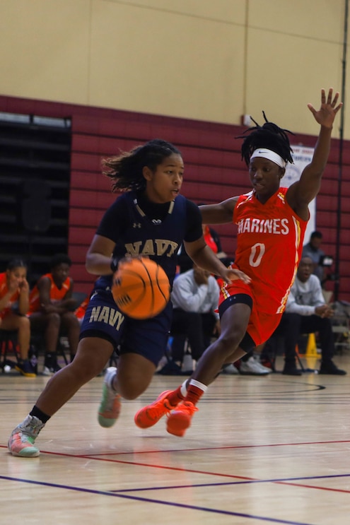 U.S. Marine Corps Sgt. Tashiara Sheftall, an administrative specialist with Marine Corps Air Station Cherry Point, North Carolina, guards the opposing team during the 2022 Armed Forces Men’s and Women’s Basketball Championship at Naval Base San Diego, California, Nov. 8, 2022.