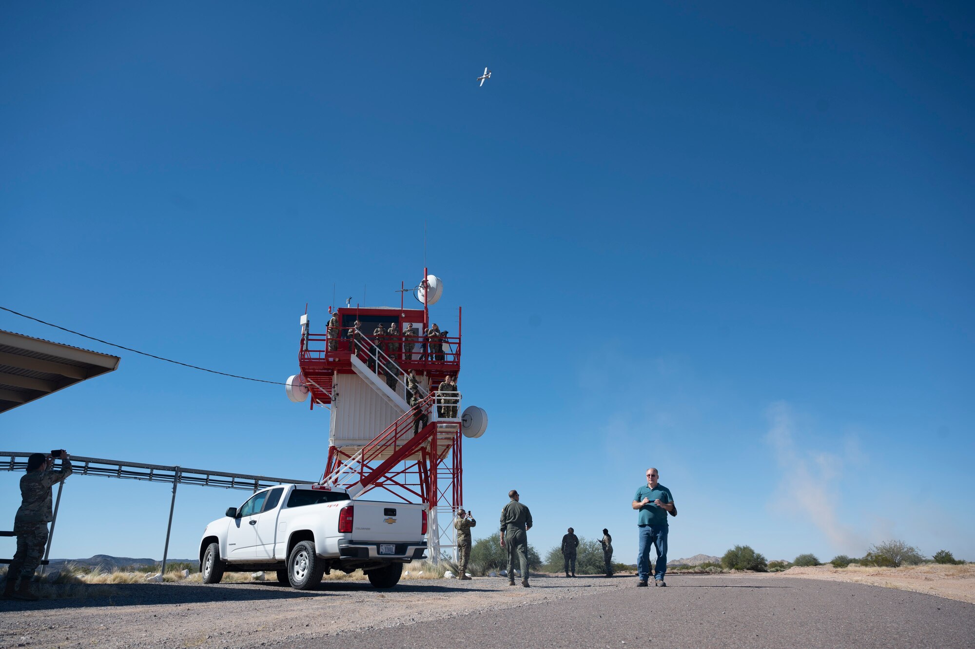 Pictured above is an aircraft flying through the air over a tower.