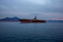 The Nimitz-class aircraft carrier USS George H.W. Bush (CVN 77), along with the embarked staff of Carrier Strike Group (CSG) 10, arrives in Naples, Italy, for a scheduled port visit Nov. 28, 2022.
