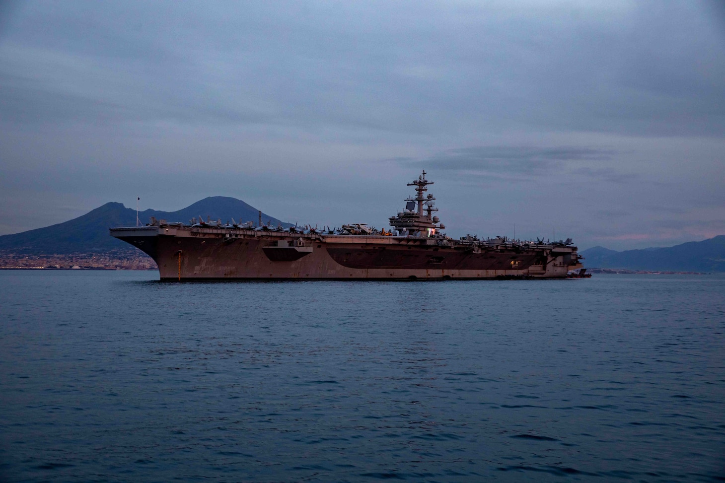 The Nimitz-class aircraft carrier USS George H.W. Bush (CVN 77), along with the embarked staff of Carrier Strike Group (CSG) 10, arrives in Naples, Italy, for a scheduled port visit Nov. 28, 2022.