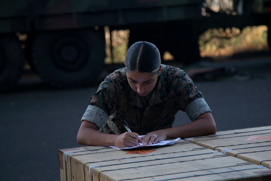 U.S. Marine Corps Cpl. Yazleen Feliciano, quality assurance safety advisor, Headquarters Battalion, Ammunition Supply Point, fills out a DD Form 1348 for the unit receiving the ammunition, Marine Corps Base Hawaii, Nov. 17, 2022. Various units on MCBH, including the 13th Marine Expeditionary Unit, were supplied ammunition to support training exercises and ranges. (U.S. Marine Corps photo by Lance Cpl. Terry Stennett III)