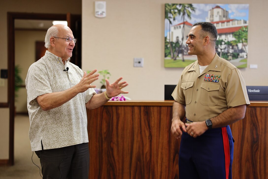 U.S. Marine Corps Col Speros Koumparakis, commanding officer, Marine Corps Base Hawaii, meets with Mayor Rick Blangiardi, mayor of Honolulu, to cut a birthday cake at City Hall in Honolulu, Hawaii, Nov. 16, 2022. The purpose of the visit was to share the tradition of cutting a cake in honor of the 247th birthday of the Marine Corps with the Mayor and city officials of Honolulu. (U.S. Marine Corps photo by Chief Warrant Officer 2 William Faffler)